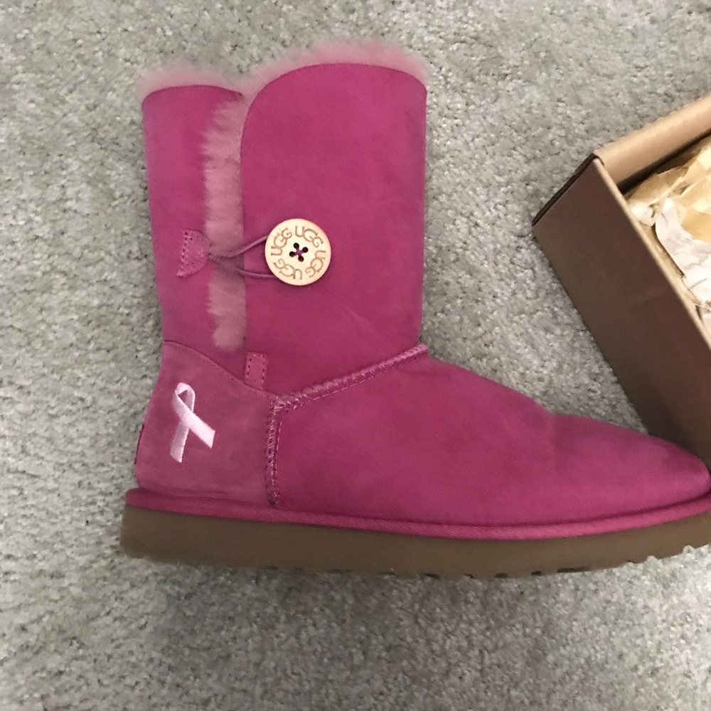 Woman’s pink Ugg breast cancer boots